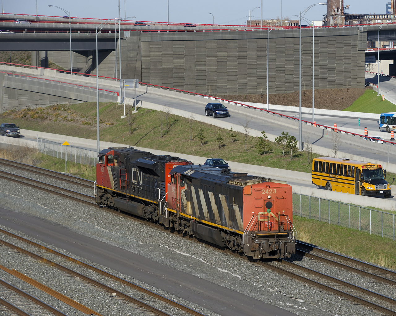 A cowl is leading long hood forward as CN 585 heads from Southwark Yard to Taschereau Yard light power with CN 2423 & CN 8020. They will wye a unit and pick up their train there before heading to Brockville.