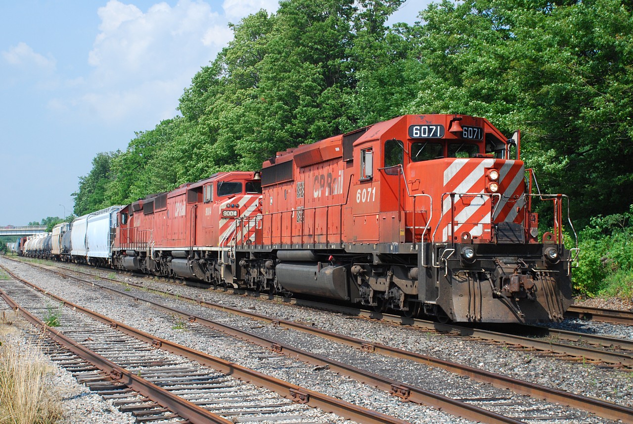 On a day that started at Bathurst St. in Toronto to watch the morning GO rush, late morning we relocated to CP Guelph Jct.  CP 421 came along mid-afternoon with a consist that even in 2010 was pretty rare.  Despite all the driving I'm glad we had to good sense to chase it to Woodstock.  After a brief delay waiting for OSR to clear, CP 421 is shown at Oxford St. continuing on their way west.  It was a very hot day so the crew wisely had the front door open to get a breeze in the cab.  And check out that polished brass bell on 9004!  It sure beats a pair of GEs.