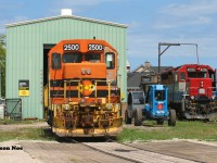 Just as the morning fog has burned-off towards Lake Huron, QGRY 2500 & RLK 4095 are seen taking in the warm summer rays at the Goderich-Exeter Railway's Goderich shop. QGRY 2500 was continuing to receive extensive repairs by local shop crews while RLK 4095 was ready to be lifted and placed on train 581, which had just arrived from bringing-up several salt hoppers from the harbour.



