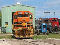 Just as the morning fog has burned-off towards Lake Huron, QGRY 2500 & RLK 4095 are seen taking in the warm summer rays at the Goderich-Exeter Railway's Goderich shop. QGRY 2500 was continuing to receive extensive repairs by local shop crews while RLK 4095 was ready to be lifted and placed on train 581, which had just arrived from bringing-up several salt hoppers from the harbour.



