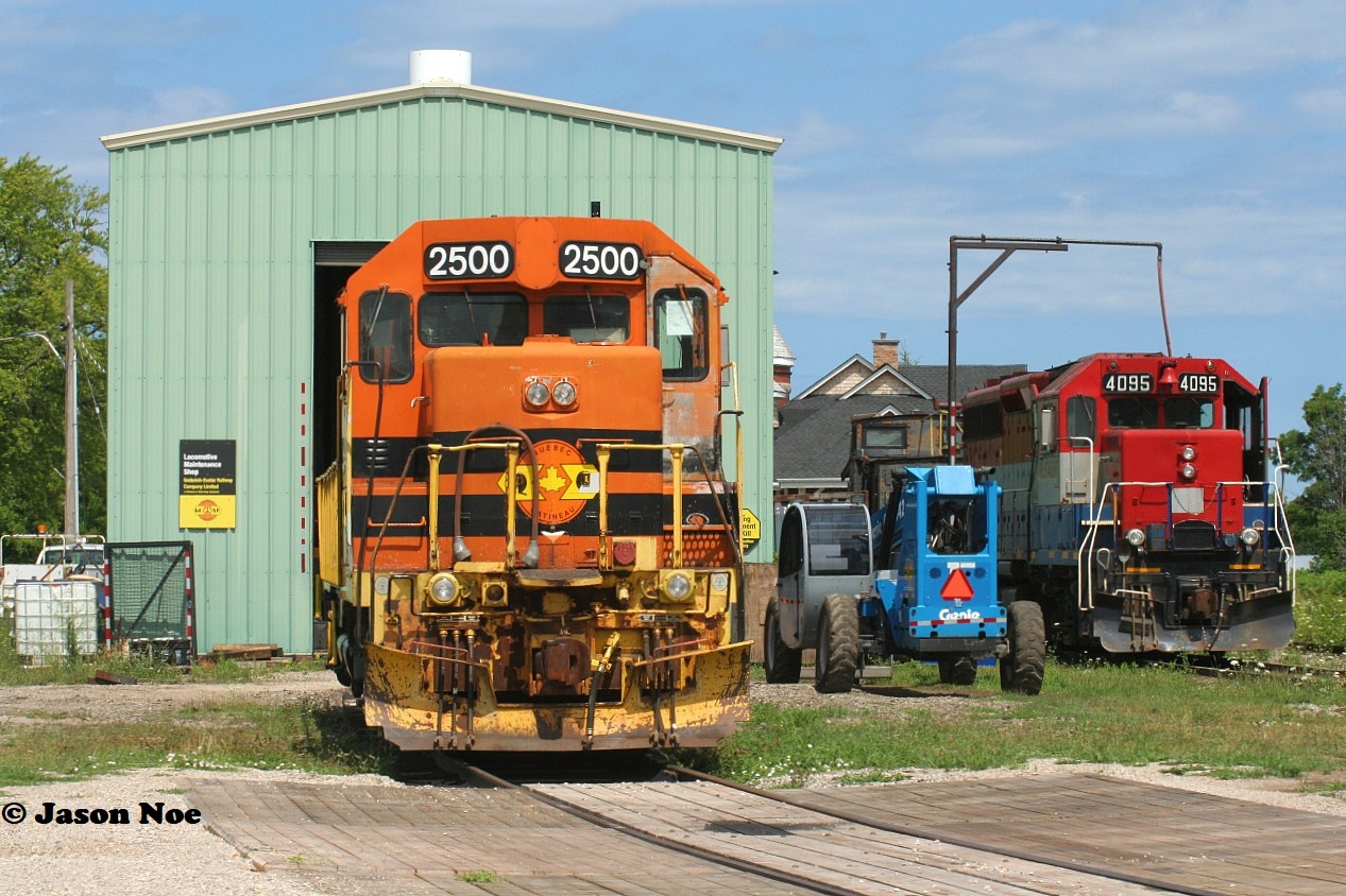 Just as the morning fog has burned-off towards Lake Huron, QGRY 2500 & RLK 4095 are seen taking in the warm summer rays at the Goderich-Exeter Railway's Goderich shop. QGRY 2500 was continuing to receive extensive repairs by local shop crews while RLK 4095 was ready to be lifted and placed on train 581, which had just arrived from bringing-up several salt hoppers from the harbour.