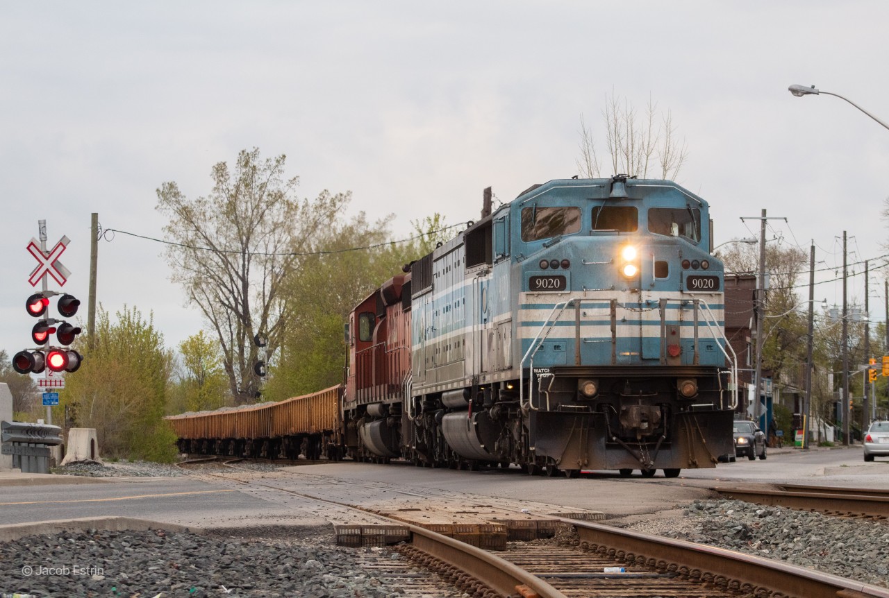 With the last bit of daylight slowly fading away, CMQ 9020 leads a Southbound Ballast train through Old Weston Road on the approach to Osler with a smaller sized train on a warm May evening.