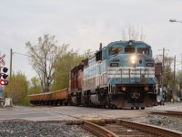 With the last bit of daylight slowly fading away, CMQ 9020 leads a Southbound Ballast train through Old Weston Road on the approach to Osler with a smaller sized train on a warm May evening.