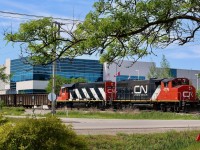 Trying to make the most of an urban industrial scene. CN 547 doesn't have too many shootable locations once it enters Milton, and the old glass lead only has one accessible crossing so variety of shots is definitely lacking. When I saw clean painted 4713 in classic stripes was in the consist I had to try my best for at least one shot. Here the train has just backed across Market street and is about to hook onto a long cut of auto frames out of Magna before heading back to the Halton sub.