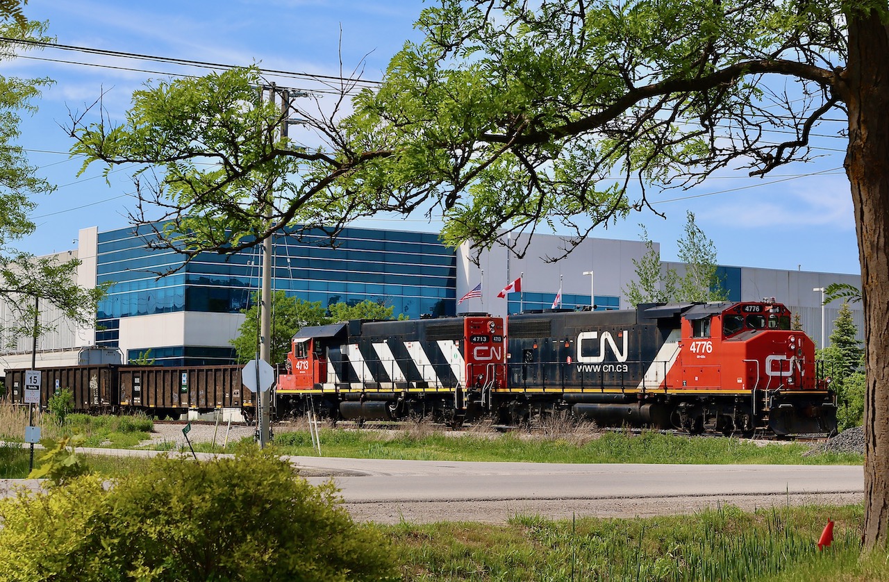 Trying to make the most of an urban industrial scene. CN 547 doesn't have too many shootable locations once it enters Milton, and the old glass lead only has one accessible crossing so variety of shots is definitely lacking. When I saw clean painted 4713 in classic stripes was in the consist I had to try my best for at least one shot. Here the train has just backed across Market street and is about to hook onto a long cut of auto frames out of Magna before heading back to the Halton sub.