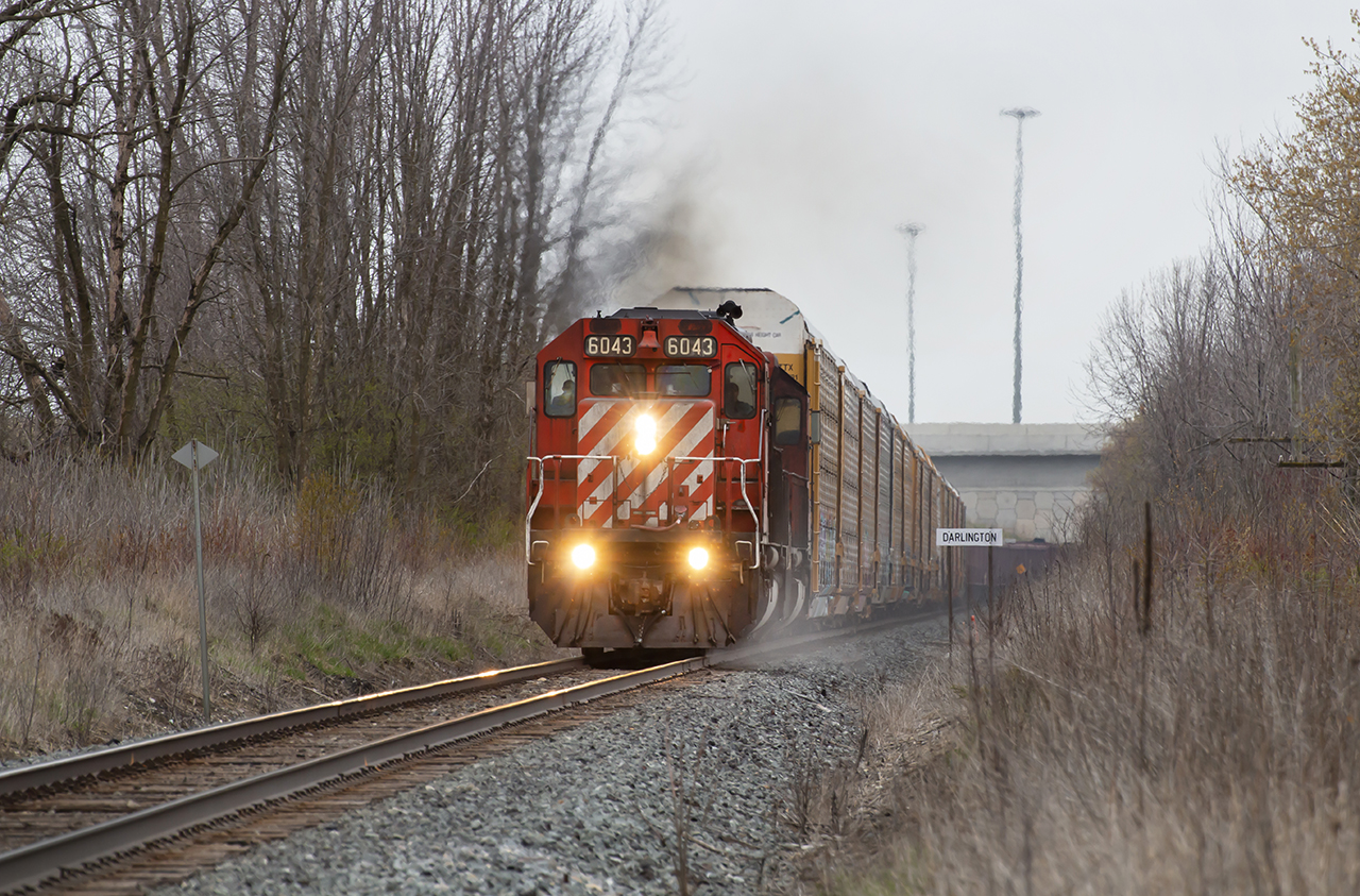 CP ballast train throttles out of Darlington bound for NY. Grabbing a string of racks from Agincourt holding nothing back with the sand on and all flying for Smith Falls.