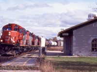 I regret not spending more time over the years along CN's Kingston subdivision. It was never disappointing the times I did spend. From what I recall CN local 590 was based in Bellville and depending on the day of the week it would head either east to Kingston or west to Couburg or Port Hope often with two or three GP9RM's. Luckily I photographed both assignments years ago. Times have changed unfortunately and it seems the GP9RM's have been replaced with newer four and six axle units. It seems a fair bit of local traffic has dried up especaially after visiting Couburg recently and finding no sign of local traffic in the small yard. This day the train was finished all local work along the line and was homeward bound as it storms past the restored station in Napanee, back then rented out as a hair dresser but still also used by VIA Rail.
