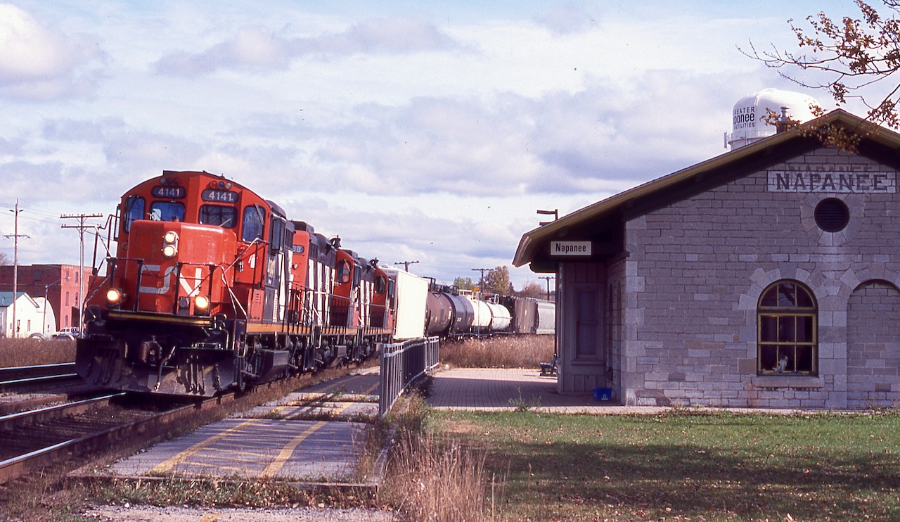 I regret not spending more time over the years along CN's Kingston subdivision. It was never disappointing the times I did spend. From what I recall CN local 590 was based in Bellville and depending on the day of the week it would head either east to Kingston or west to Couburg or Port Hope often with two or three GP9RM's. Luckily I photographed both assignments years ago. Times have changed unfortunately and it seems the GP9RM's have been replaced with newer four and six axle units. It seems a fair bit of local traffic has dried up especaially after visiting Couburg recently and finding no sign of local traffic in the small yard. This day the train was finished all local work along the line and was homeward bound as it storms past the restored station in Napanee, back then rented out as a hair dresser but still also used by VIA Rail.