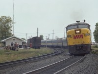 VIA 6761 and 6615 power a passenger train eastward around the old stone station at Napanee. The MLW FPA-4 was built in 1958,retired by 1989 and presumably scrapped.