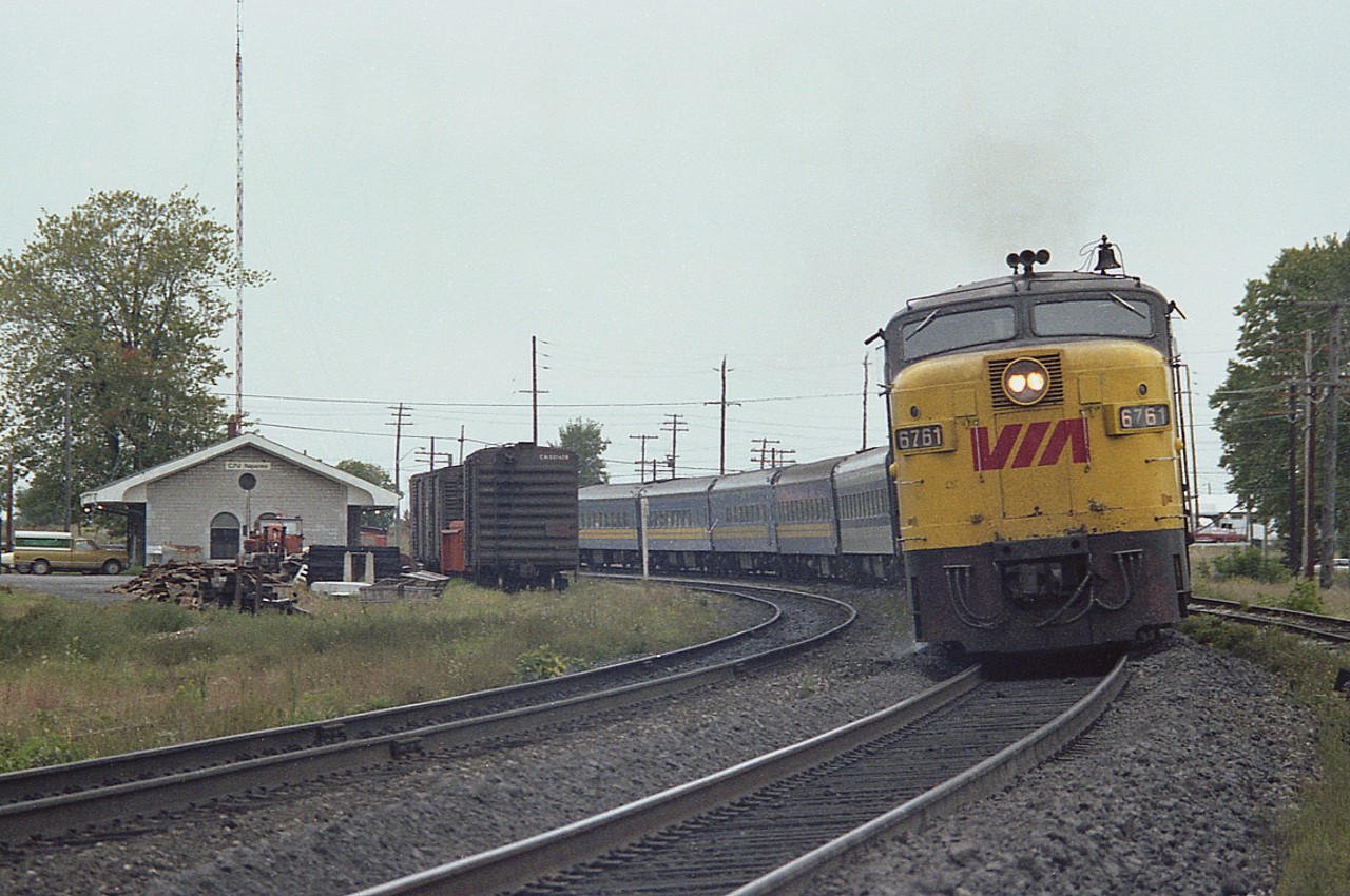 VIA 6761 and 6615 power a passenger train eastward around the old stone station at Napanee. The MLW FPA-4 was built in 1958,retired by 1989 and presumably scrapped.