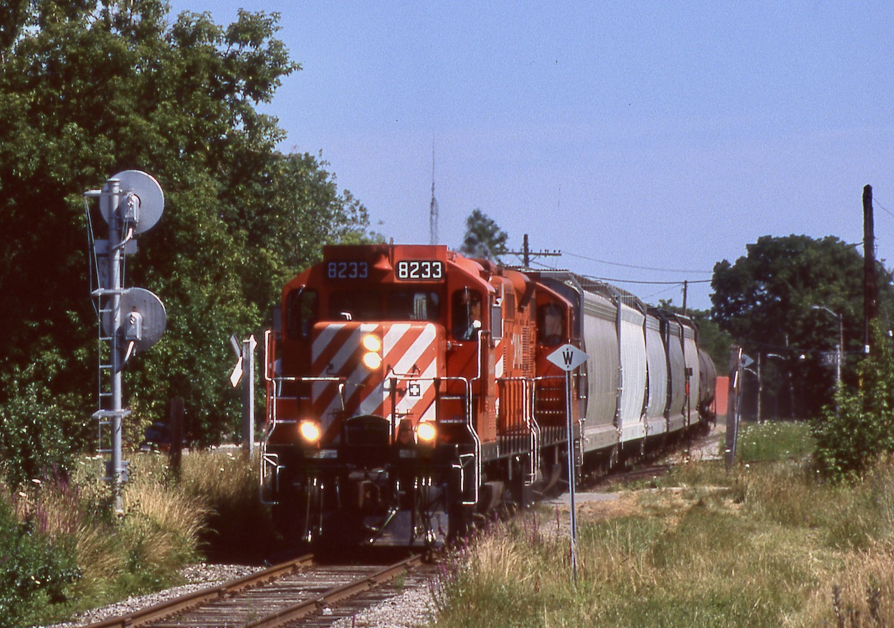 One of my few catches of CP's late afternoon "Moonlight" to Orangeville late in the trains existence. Sadly by tis time the old CP station here was moved to a piece of farm land and rotting away. The train and its two GP9U's have just been given the light to cross CN's busy Halton sub. Luckily the late day running of this train provided much better northbound lighting than today's OBRY operations do. It appears this line will fall silent by years end, but hopefully its future will somehow improve, after all the old station that sat here rase amazingly resurrected and is now a part of Mount Pleasant's community centre in Northeast Brammpton.