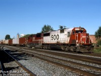 Back to back SOO Line SD60's, as with other SOO power, were common in Southern Ontario on CP freights back in the day. On one sunny morning in August 1999, SOO SD60 6040 and 6045 (both in as-delivered liveries, as starting with 6042 SOO switched from red/white to all-red) head up CP intermodal #502, exercising trackage rights over CN's Oakville Sub as they enter CP's Canpa Sub at Canpa (the west end of Mimico). From there they'll swing north and head up the Canpa to Obico Yard. Both today survive on CP as rebuilt 6200's.
<br><br>
<i>Peter Jobe photo, Dan Dell'Unto collection slide.</i>