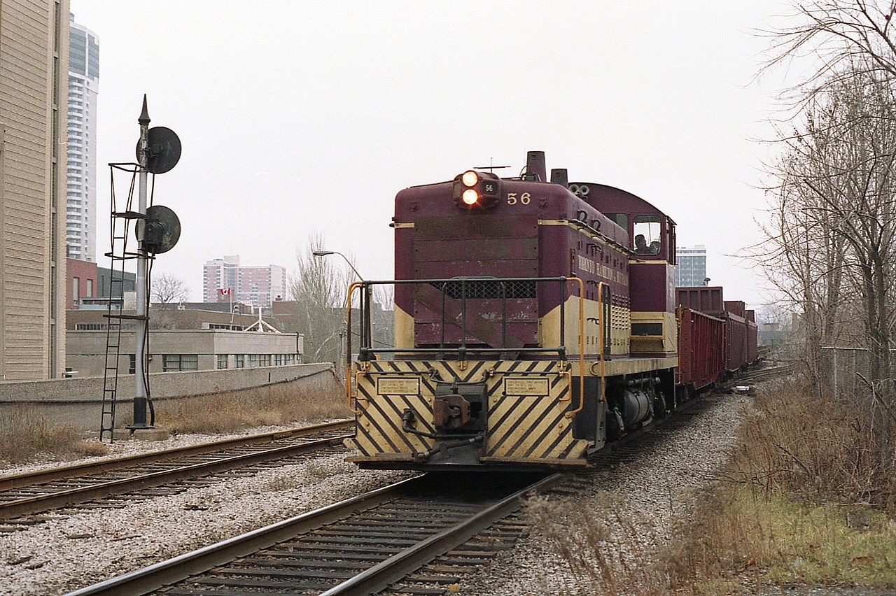 It certainly doesn't look like Christmas.  But it is the 29th of December, 1986, as TH&B 56 trundles along with a few cars in downtown Hamilton area, heading westward.