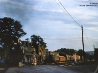 CPR extra 1048 (D10h, MLW, Dec. 1912) is seen pulling through Woodstock crossing the long removed Givins Street railway crossing on the St. Thomas Sub.  At right is the former <a href=http://www.trainweb.org/oldtimetrains/CPR_London/aerial_woodstock_1953.jpg>engine servicing area</a> for the local branch line assignments.  In barely a decade the servicing area will be filled with diesel locomotives ranging from <a href=http://www.railpictures.ca/?attachment_id=39641>MLW RS3s</a> to <a href=http://www.railpictures.ca/?attachment_id=40147>MLW S3s, RS18s, and GMD SW1200RS</a> units.  Check out the recent post of Carl Noe’s shot <a href=http://www.railpictures.ca/?attachment_id=45458>facing the other direction in 2001.</a><br><br><i>Original Photographer Unknown, Jacob Patterson Collection Slide.</i>