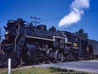 CNR J-7-c Pacific 5302 is seen on its last stretch of the Fergus Subdivision headed for the Brampton Subdivision and a station stop at Guelph with train 172, seen here on the Fergus crossing Paisley Street at mile 30.47.  The switch just ahead of the locomotive should be lined for the normal position, which at the time routed trains through the <a href= http://www.railpictures.ca/?attachment_id=17326>Crimea Street wye (Fergus Sub main)</a> and onto the Brampton Sub just east of Edinburgh Road (mile 49.54).  It will likely take the crossover there onto the south main for the short jaunt to downtown Guelph before continuing onto Toronto.  In the background at left it would appear to be the houses at 146 and 148 Edinburgh Road North, though they are in a row of six virtually identical houses.<br><br>Originating at Owen Sound with a <a href= https://s3.amazonaws.com/content.sitezoogle.com/u/131959/ece8a0769559fba8d6a5d3c0925f8400ea0fdb10/original/cnr-tt-57-100-to-126.pdf?response-content-type=application%2Fpdf&X-Amz-Algorithm=AWS4-HMAC-SHA256&X-Amz-Credential=AKIAJUKM2ICUMTYS6ISA%2F20210522%2Fus-east-1%2Fs3%2Faws4_request&X-Amz-Date=20210522T024247Z&X-Amz-Expires=604800&X-Amz-SignedHeaders=host&X-Amz-Signature=a9d4d82ba22cea9fe1458003d54d44f3fc96fb8397c6bd4fba2592d97085e2d0>departure time of 0550h (1956 timetable,)</a> 172 would travel south via Palmerston arriving 0800h, continuing to Guelph arriving 0940h, and finally Toronto, arriving 1110h.  This image was likely snapped just after 0930h. Based on the timetable the train would return north to Owen Sound as train 175, departing Toronto at 0535h, Guelph at 1925h, Palmerston at 2045h, and finally due into Owen sound at 2310h.  Both 172 and 175 were daily except Sunday trains.<br><br>CNR 5302 was built in August 1920 by MLW as part of an order for ten such locomotives (5295 - 5304). At the time of this photo it had less than a year to go before meeting the torch in May 1959.<br><br><i>Original Photographer Unknown, Jacob Patterson Collection Slide.</i>