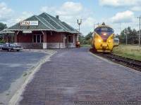 The fourth and final TEE trainset purchased by the Ontario government for use on the Ontario Northland Railway’s Northlander operation is seen making its southbound station stop at the 1917 Orilla station headed for Toronto.<br><br>Less than a year <a href=http://www.railpictures.ca/?attachment_id=12462>since arrival on Canadian soil,</a> the 4 sets arrived originally <a href=http://www.railpictures.ca/?attachment_id=35585>numbered 1900 – 1903</a> and were renumbered to 1980 – 1983 soon after.  With the retirement of the European power cars due to poor performance in harsh Canadian temperatures in 1979 and <a href=http://www.railpictures.ca/?attachment_id=40322>replaced by modified F-units,</a> they would again be renumbered to 1984 – 1987 and the sets finally retired in the early 1990s.  Some cars were sent back to Europe for display in a museum, while a couple still remain on the ground <a href=http://www.railpictures.ca/?attachment_id=20706>in a fenced lot in North Bay.</a><br><br>Since the removal of the tracks in 1996, the station, owned by the city, has continued to serve as a stop for Ontario Northland buses, a Service Ontario office, and other small operations until April 8, 2019 when the property was purchased by a numbered company.  The city had attempted to sell the property a few years earlier but paused the sale until the structure could be designated a protected heritage site.  A partner of the company, Eric Pong,  <a href=https://www.orilliamatters.com/local-news/former-orillia-train-station-will-become-venue-to-showcase-locomotive-history-3553481>recently announced the intentions of the owners</a> to use the building as an art gallery and museum focusing on the heritage of the site and Orillia’s railways.<br><br>More Orillia:<br><a href=http://www.railpictures.ca/?attachment_id=43959>Eastbound Canadian, April 1979</a> by Barry Schroeder.</br><a href=http://www.railpictures.ca/?attachment_id=22413>Hooping orders to the westbound Canadian, June 1980</a> by Steve Danko.<br><br><i>Dorothy F. Wiener Photo, Jacob Patterson Collection Slide.</i>
