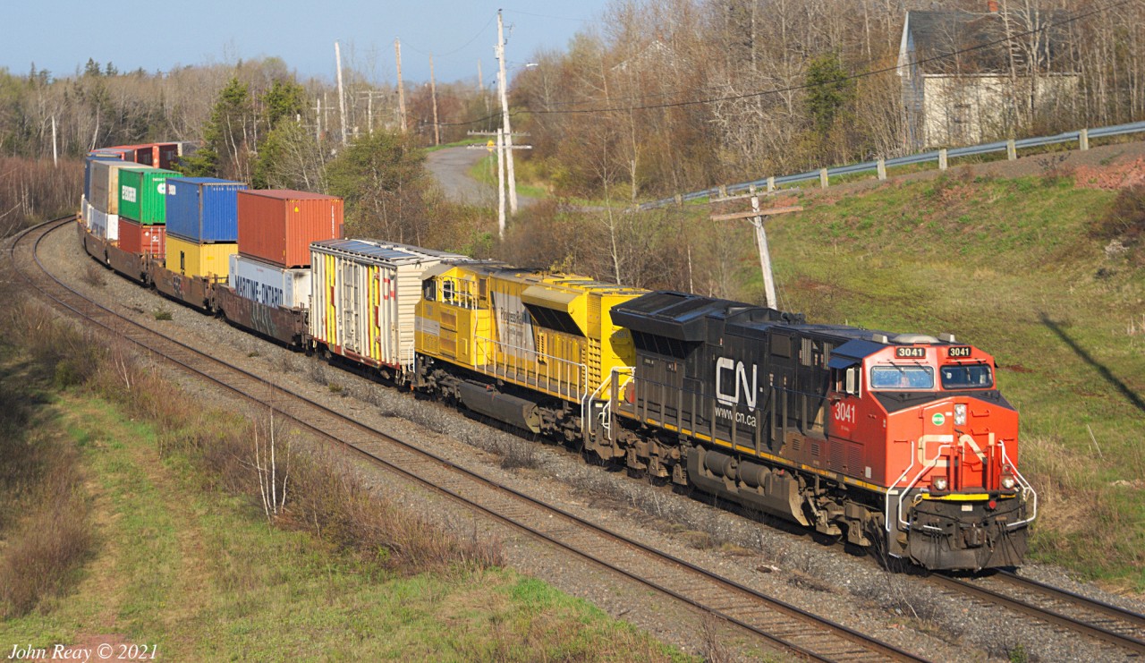 May 17th, 2021 @ 0752 Springhill Jct. Intermodal 120 had Progress Rail 7201 trailing. What's the story with the funky paint scheme sported by the boxcar behind the power?