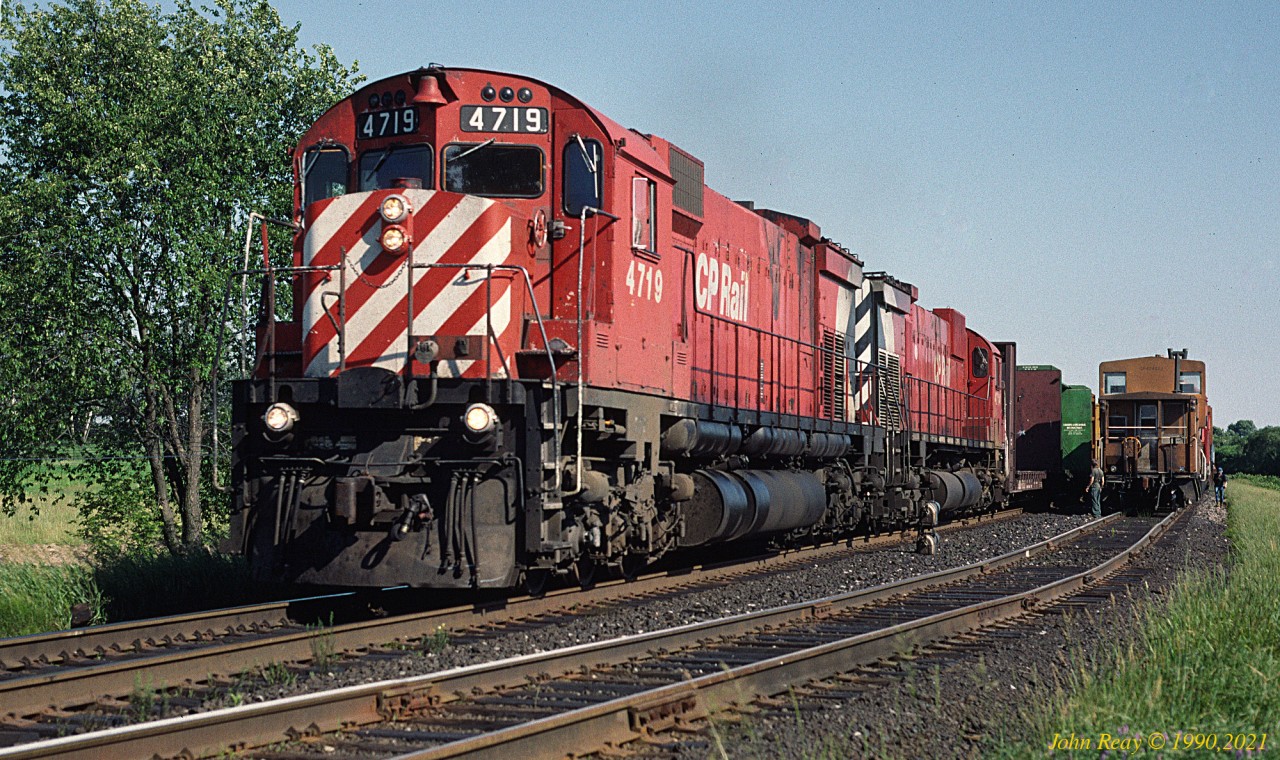 Westbound freight led by CP MLW M-636 4719 holds the main, and is being inspected by the tail end crew of an eastbound in the siding at Lovekin, CP Belleville sub, in September 1990.
