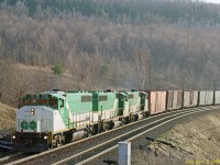 Three (leased for the weekend) GO Transit GP40-2Ls lead train 904 down the Niagara escarpment on Sunday afternoon in April 1988.