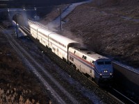 The International accelerates out of the St. Clair River tunnel in to the first sunlight on Canadian soil since leaving Michigan on the other side of the river.  At the top of the grade, the train will make a stop at the Sarnia station.  Was this near the end of the International?  Didn't it usually have more than three cars?  We photographed counterpart VIA 85 at Komoka earlier that day with AMTK 37 and only three Superliner cars also.