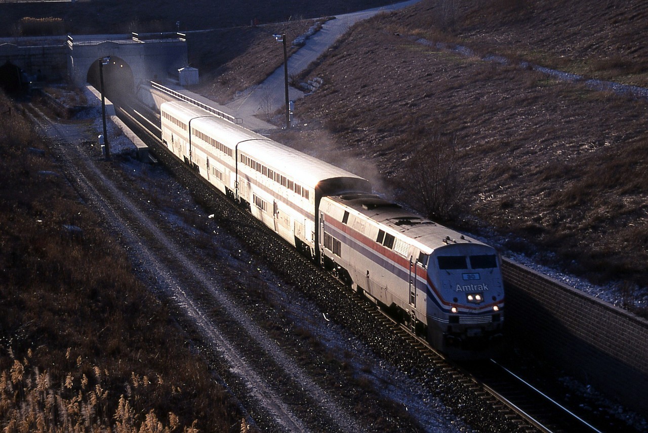 The International accelerates out of the St. Clair River tunnel in to the first sunlight on Canadian soil since leaving Michigan on the other side of the river.  At the top of the grade, the train will make a stop at the Sarnia station.  Was this near the end of the International?  Didn't it usually have more than three cars?  We photographed counterpart VIA 85 at Komoka earlier that day with AMTK 37 and only three Superliner cars also.
