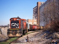 CN 1437 was recently purchased by the Waterloo Central Railway.  The GMD-1u was assigned a notable role in 2003, being leased to the power-short Port Colborne Harbour Railway.  It is seen here switching grain hoppers at the massive Robin Hood Flour elevator in Port Colborne.  This was the same day Dad and I photographed TRRY 110 on Townline Road (between St. Catharines and Thorold) on their way to switch Interlake Paper seen here: <a href="http://railpictures.ca/?attachment_id=12045"> http://railpictures.ca/?attachment_id=12045 </a>

