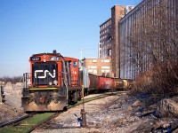 CN 1437 was recently purchased by the Waterloo Central Railway.  The GMD-1u was assigned a notable role in 2003, being leased to the power-short Port Colborne Harbour Railway.  It is seen here switching grain hoppers at the massive Robin Hood Flour elevator in Port Colborne.  This was the same day Dad and I photographed TRRY 110 on Townline Road (between St. Catharines and Thorold) on their way to switch Interlake Paper seen here: <a href="http://railpictures.ca/?attachment_id=12045"> http://railpictures.ca/?attachment_id=12045 </a>

