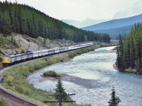 <br>
<br>
   Four F units power the daily Via #1 on approach to The Curve, next passenger stop Lake Louise station.
<br>
<br>
   Westbound at Morant's Curve, September 7, 1983 Kodachrome by John Baker, collection of Steve Danko 
<br>
<br>