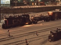 <br>
<br> 
  On a cold evening, GMD 1957 built SW1200RS  CN #1241 works the north yard beside Front Street
<br>
<br> 
  at Bathurst Street, December 18, 1976 Kodachrome by S.Danko
<br>
<br> 