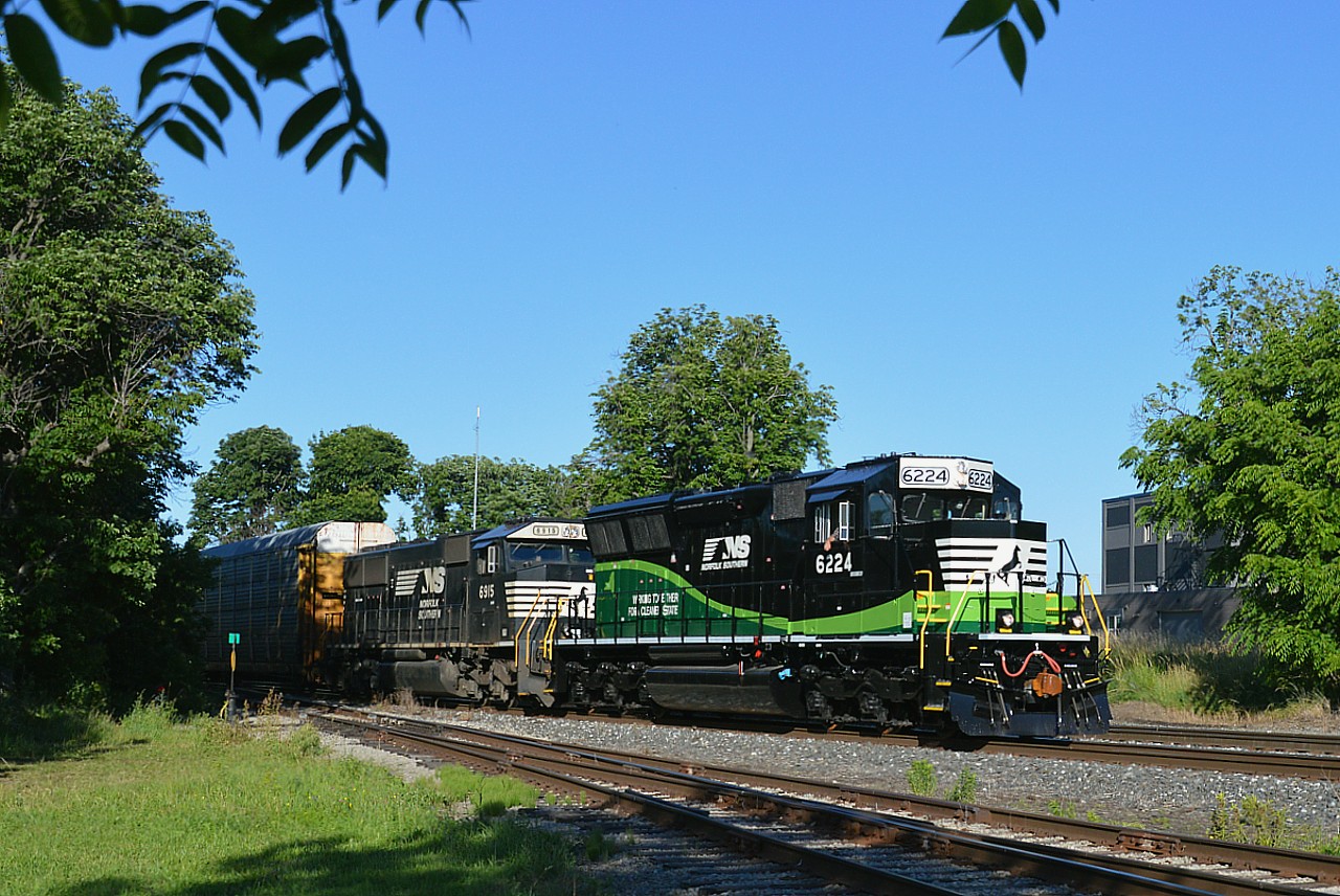My disappointment in the NS 9-1-1 leaving Buffalo was shortlived when I found out something very new was now making the transfer rounds. NS 6224, just delivered June 2021 in bright shiny paint.."going green"...one of a group of 15 new SD33ECO units rebuilt from SD40-2 locos.  The 6224 was once CR 3445. EPA Tier 3 emissions standards are met. In the series, these 3,000 HP units 6210-6214 & 6218 are assigned to the Macon, Georgia area; 6125-6217, 6219-6223 to the Atlanta, Georgia area and this; the first release since 12-2018 is assigned to the Buffalo area. (There is a small state map on the flank). The locomotives are partially funded with federal and state grants. Here's hoping we see this and possibly future units on the early evening transfers to Fort Erie. I thank Paul O'Shell for digging up for me this information provided.