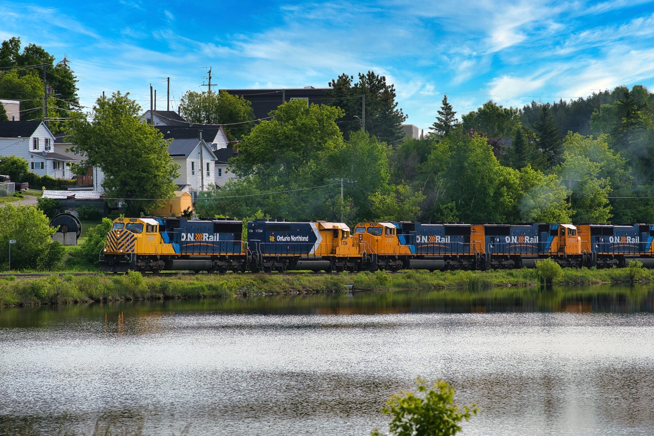 Ontario Northland Southbound 214 curves around Cobalt Lake with Historic Cobalt in the background. Headed up by ONT 2105 followed by ONT 1734, ONT 2102, ONT 2103, and ONT 2101. Mile 103 Temagami Subdivision. June 12.
