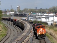 CN M321 meets CN B730 in Ville-Saint-Pierre, Qc near Turcot West. To notice is CN’s BC Rail heritage unit n. 3115 trailing second on 730. It just got its signal to proceed and drop off some bad order cars on the merchandise track.