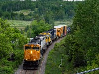 After some impromptu repairs to <b>The Ghost</b> (ONT 1740) as Southbound ONT 214 crawled through Haileybury it's now back up to line speed and approaching the Highway 11b Overpass entering Cobalt, ON.<br>
An Allied Track Maintenance Crew waits patiently ahead on the Cobalt siding for 214 to pass before they can continue working South.<br>
Headed up by ONT 2102 followed by ONT 1740, ONT 2105, and ONT 1733<br>June 19, 2021