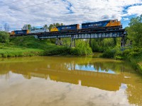 Northbound 113 having just cleared the speed reduction through town throttles up as it crosses the Wabi River bridge at Mile 113.5 Temagmai Sub. <br>
Led by ONT 2103 followed up by ONT 2105, ONT 1740, and ONT 2102.