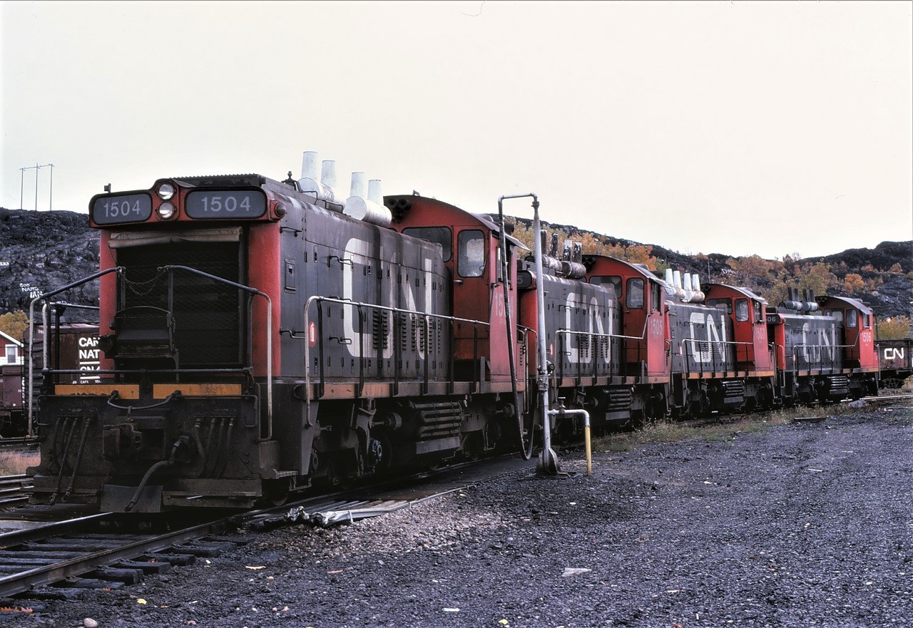 Four of CN's five 1500s take a breather at Sudbury, Ontario.  Almost consecutively numbered, 1504 1505 1507 1506, are pictured.  Missing is the 1508. The locomotives are on the west leg of the "Y" at the shop area. The 1500s weighted in at 246,000 pounds while most of the other SW100RS units tipped the scales at 222/223,000 pounds.  The extra weight of these units came in useful handling all the ore and sand traffic that Sudbury once handled.  Nothing in this scene remains.