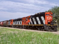 An interesting ABA set with the 4216 leading, 9198 and 4217 at the rear. The unit train has obviously stopped, possibly in Lac La Biche, and picked up a few grain hoppers on the way home. The recently applied ballast is waiting for the little army of machines to come spread and shake it into place. Photo taken at the east crossing of the hamlet of Coronado.