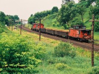 CN "Triple 5" heads westbound up the grade through Copetown under the watchful eye of a foreman as it proceeds to Paris with cars for the busy pit. Matching CN GP9RM's 7042 and 7028 are powering the Hamilton-based local with CN van 79752 on the tail-end. 