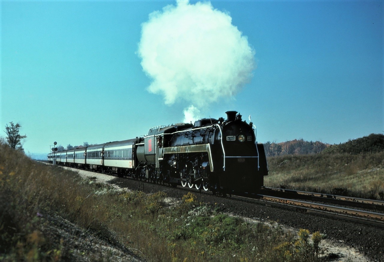 With classic "white smoke" (I know its just steam), CN 6060 heads east at approximately mile 3 of the Halton Sub on Sunday October 5 1975.  And to think we took this for granted back then!!