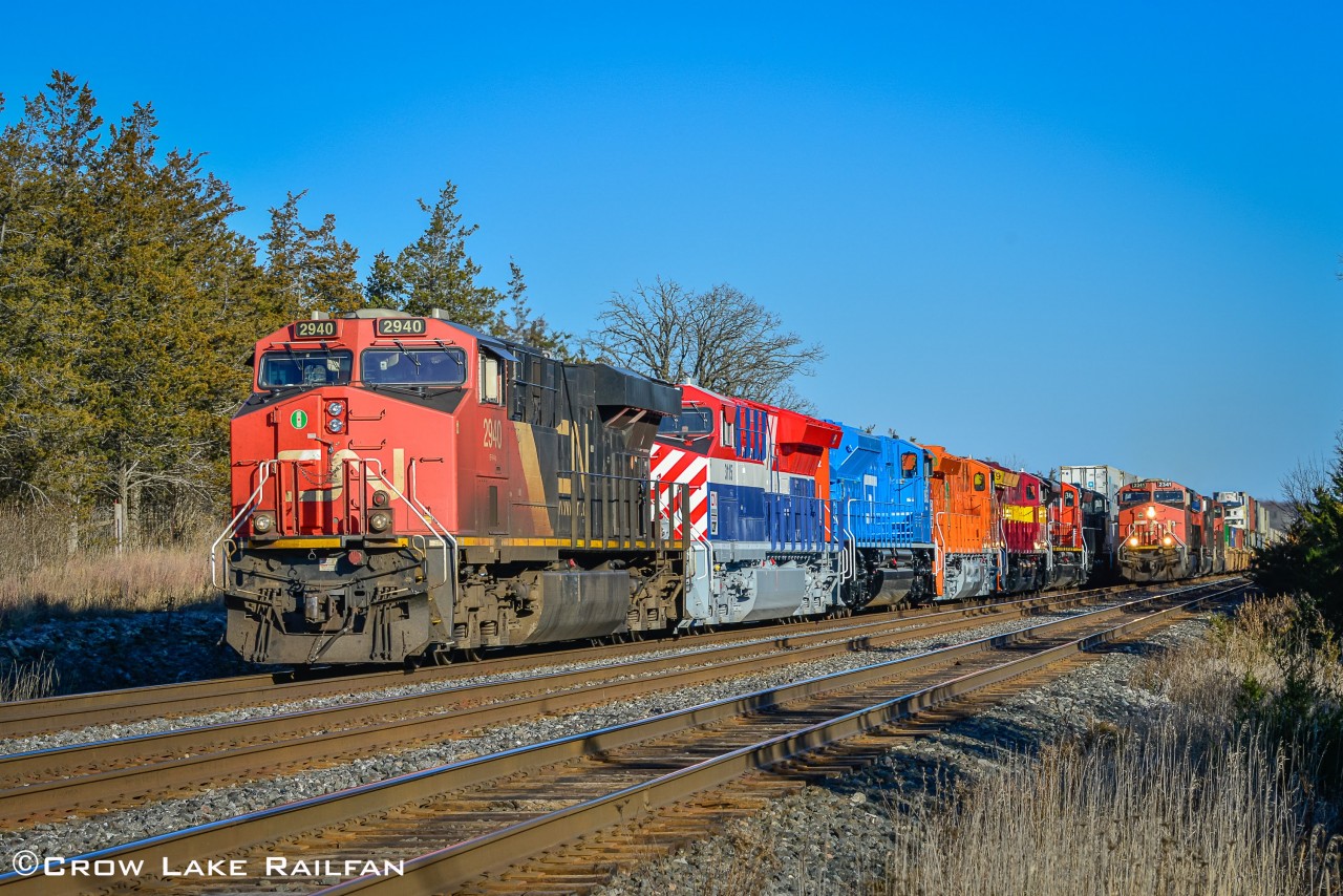 CN Q105 with all of CN's heritage units trailing ties down at Shannonville due to congestion at Mac yard while a hotshot intermodal passes.
This was quite the treat to watch unfold as the railway community came together and posted their updates and their shots of these newly released units. I made the trip from my namesake town and stopped by at the end of the rush and was surprised to only see one other railfan stop by shortly after we arrived. From what I heard it was quite the zoo and even the railway police were called however we did not see any.