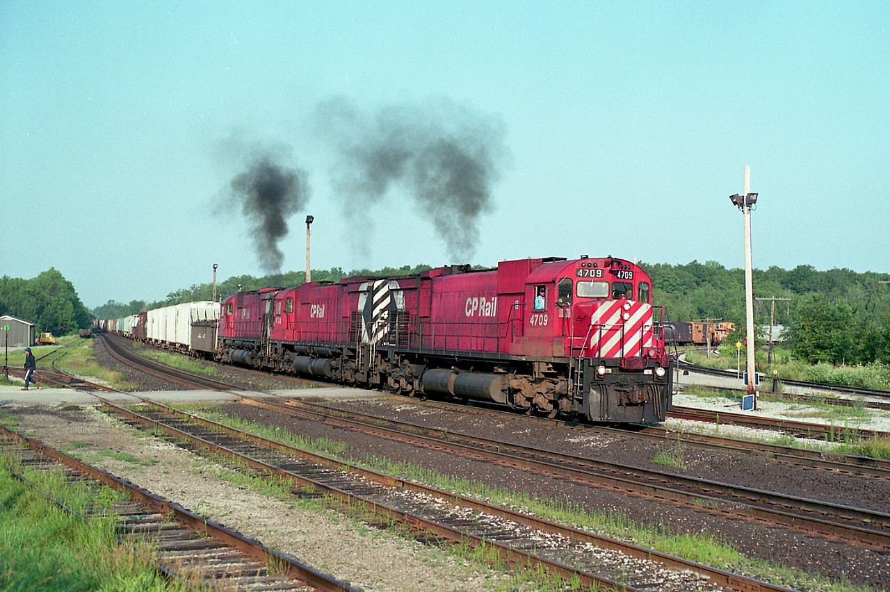 Another great morning at Guelph Jct., this day turned out to be.  Alcos behaving like Alcos. Accelerating out of the Junction eastward under smoke. The sights and the sounds will be with me forever. It was worth the drive from St. Catharines, where I lived at the time, to see a show like this; and I made it as often as I could. CP 4709, 4738 and 4720. Three M-636s. Perfect!!
I'm sorry that todays GEs do not do much for me. Spoiled, I guess.
Image shot using Mamiya 645 1000-S medium format camera, 400 ISO Kodak film, 500 F5.6; 90 MM fixed lens; for those who are interested.