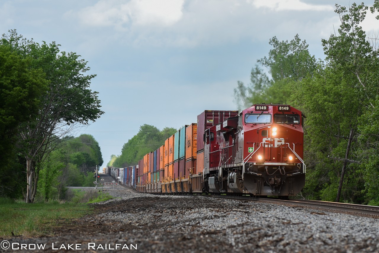 CP 143, a daily intermodal train heading for Chicago, crests the hill after passing highway 43 in Monkland.