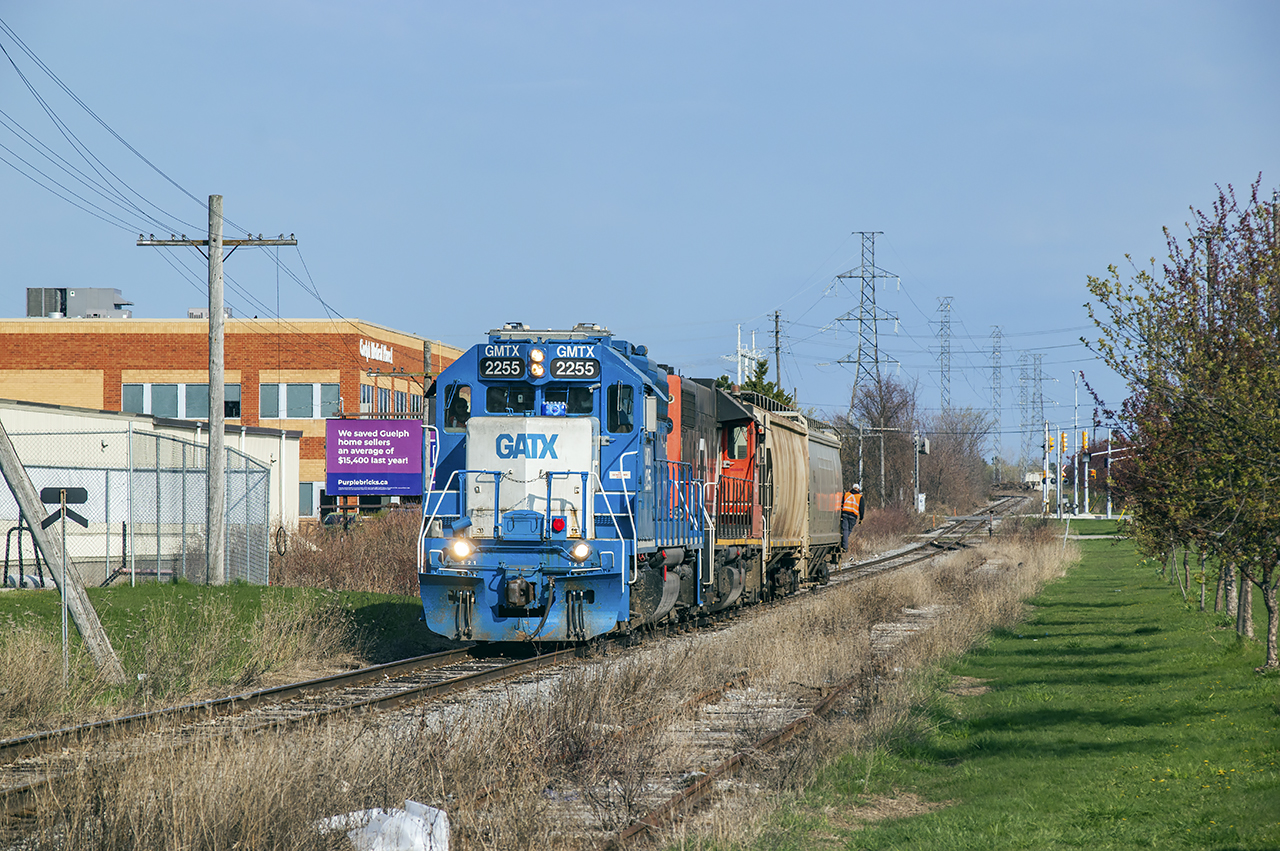 CN 542 shoves a short cut of hoppers up the old Fergus subdivision headed for the interchange with the Guelph Junction Railway, where the hopper cars are off in the distance.  542 would wye its train before continuing over to Traxxside for awhile.