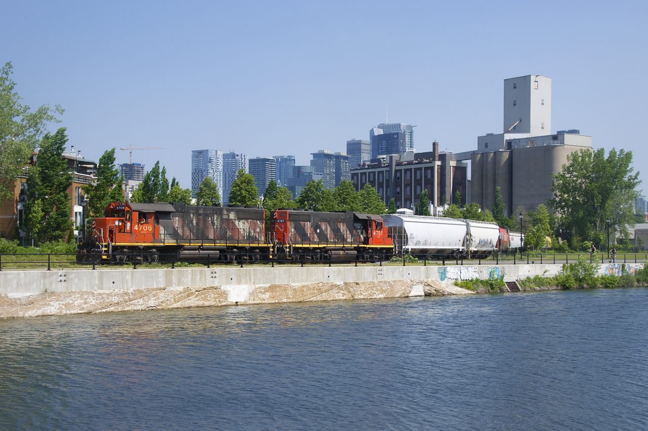 Consecutively numbered GP38-2's (CN 4706 & CN 4707) are shoving seven cars towards the Ardent Mills at right. Six of them are grain loads for the mill, while the first car behind the power is for O-I Canada, where this train will go when they are done here.