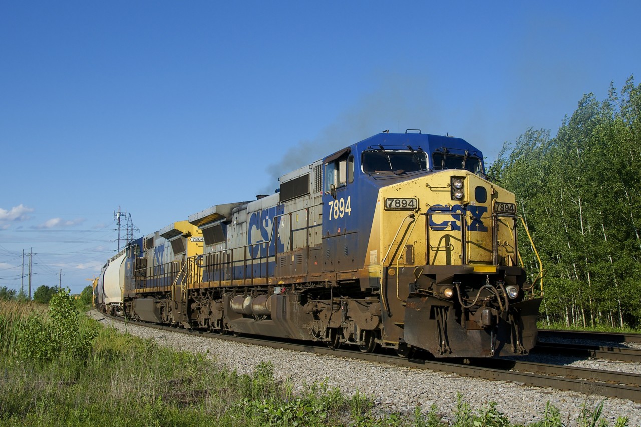 A pair of reactivated Dash8-40CW's in the YN2 paint scheme (CSXT 7894 & CSXT 7864) are the power on a 12-car CSXT B763 as it departs Beauharnois, bound for Massena. I got lucky here, with the conductor walking up to the head end as I arrived and the train departing a minute later.