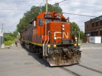 CN 4706 & CN 4707 are about to grab a plastic pellets car that is blocking their access to the Kruger plant, where they will spot the boxcar in the background. Two clients here share one track, so if there is a plastic pellets car spotted at Imaflex and Kruger needs a boxcar, they need to temporarily move the pellet car.