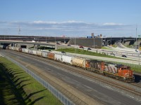 CN 596 has a long transfer from the Port of Montreal as it heads towards Taschereau yard with faded zebra striped CN 4774 & CN 4706 for power on a lovely spring evening.