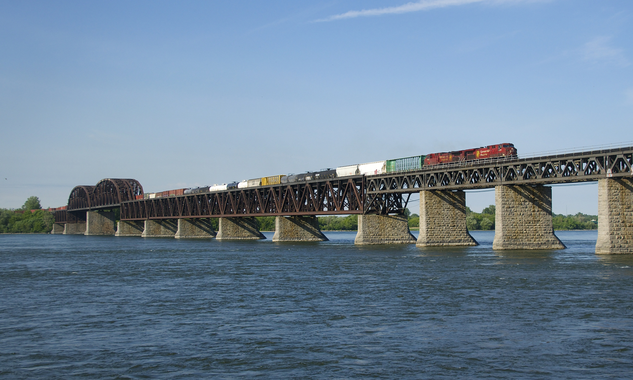 CP 9836 & CP 9808 lead a slightly late CP 253 over the St. Lawrence River on a sunny morning.