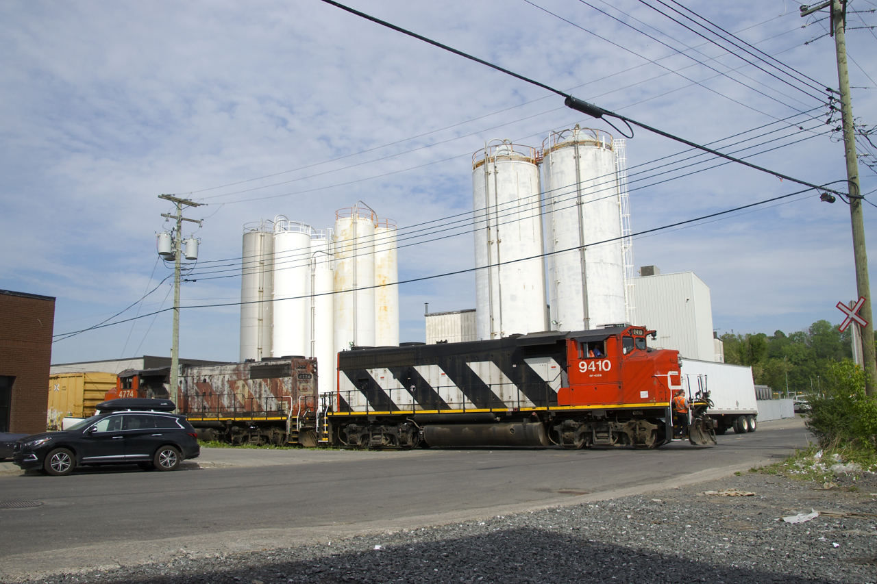 The conductor has gotten back on lead unit CN 9410 after flagging Place Turcot as the Pointe St-Charles Switcher leaves the Kruger plant.