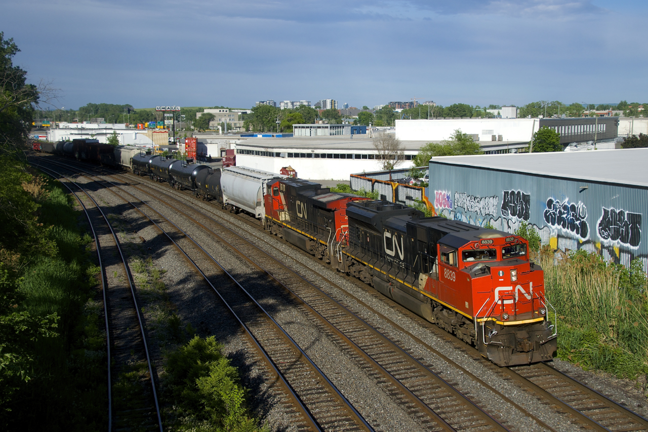 CN 8839 & IC 2725 are in charge of CN 321 as it passes through Montreal West.