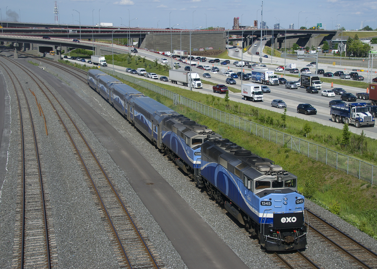 Consecutively numbered F59PH's (AMT 1345 & AMT 1346) are leading EXO 1207 as it passes afternoon rush hour traffic.